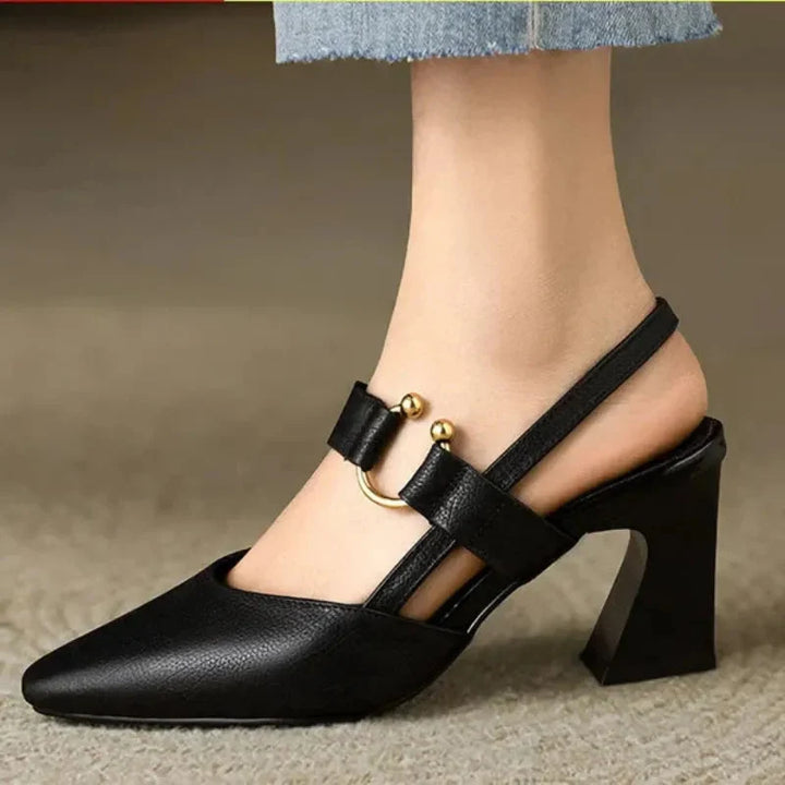 Black heels elegant slingback design with gold hardware detail and block heel on model