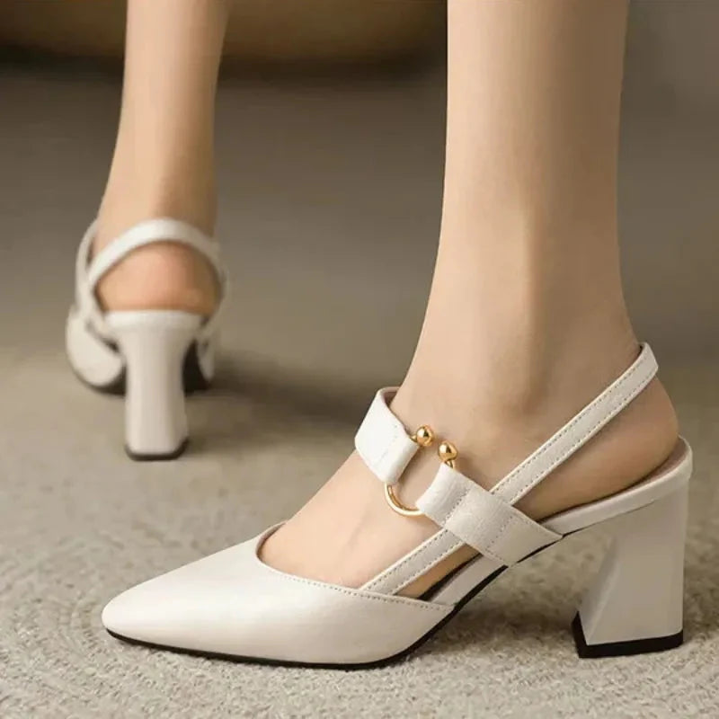 Black heels elegant slingback style showing gold-tone hardware and structured finish