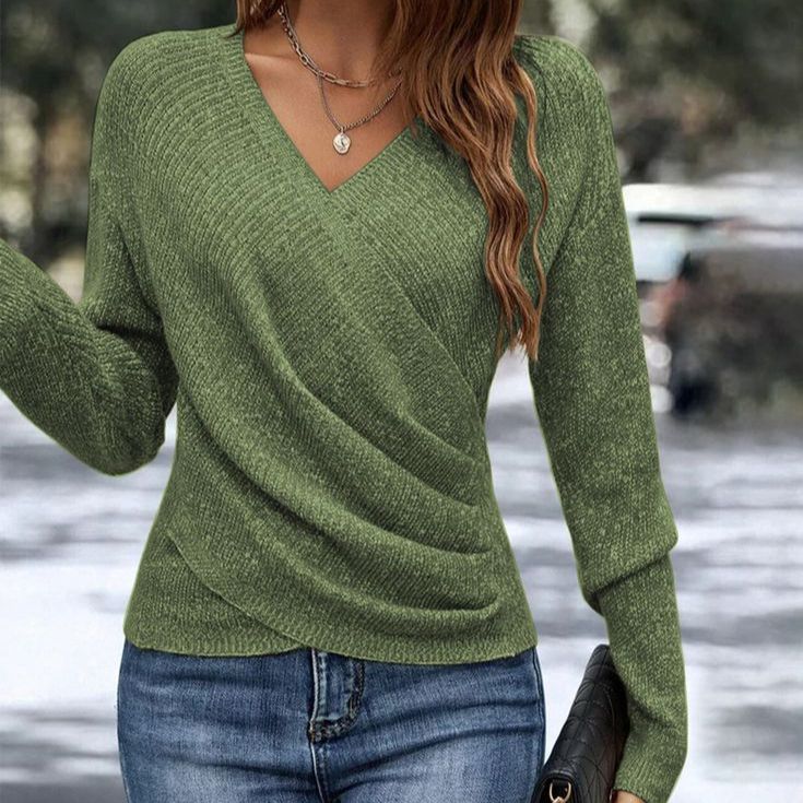 Full-length view of the women's V-neck knit sweater paired with denim jeans for casual styling