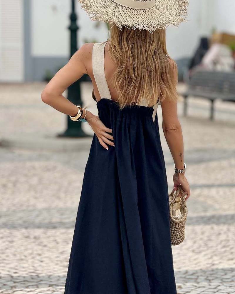 Full outfit featuring halterneck maxi dress paired with handbag for evening look