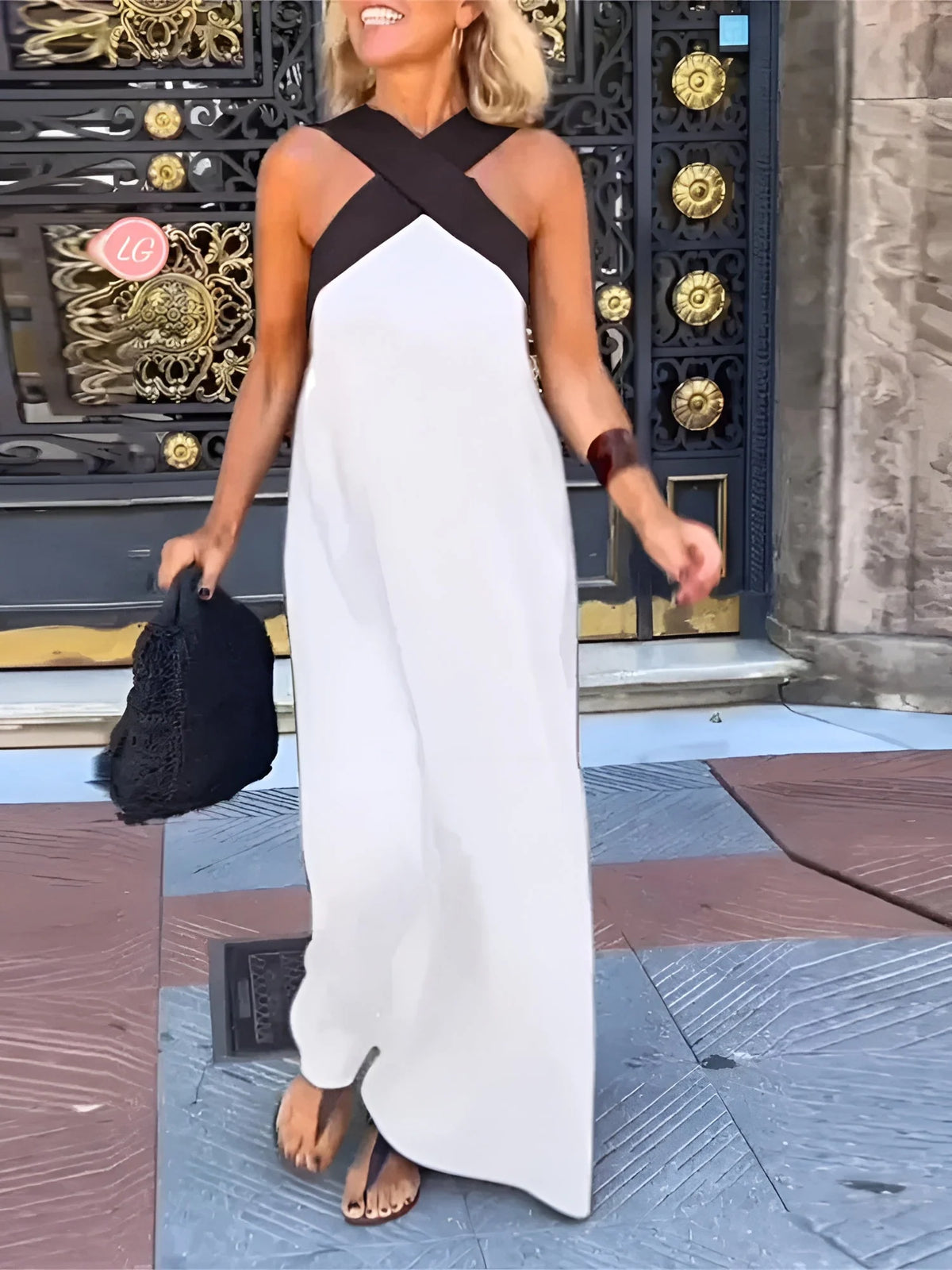 Close-up view of halterneck maxi dress showing taupe crossover neckline and structured bodice