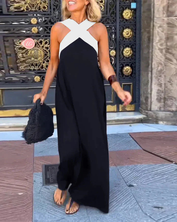 Front view of halterneck maxi dress showing sleeveless cut and floor-length hem