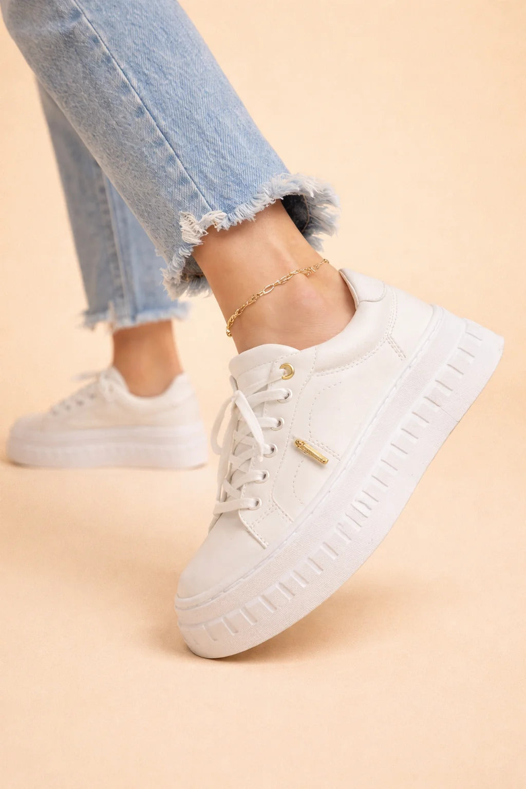 Women's platform comfort sneakers styled with cropped jeans showing height-adding sole