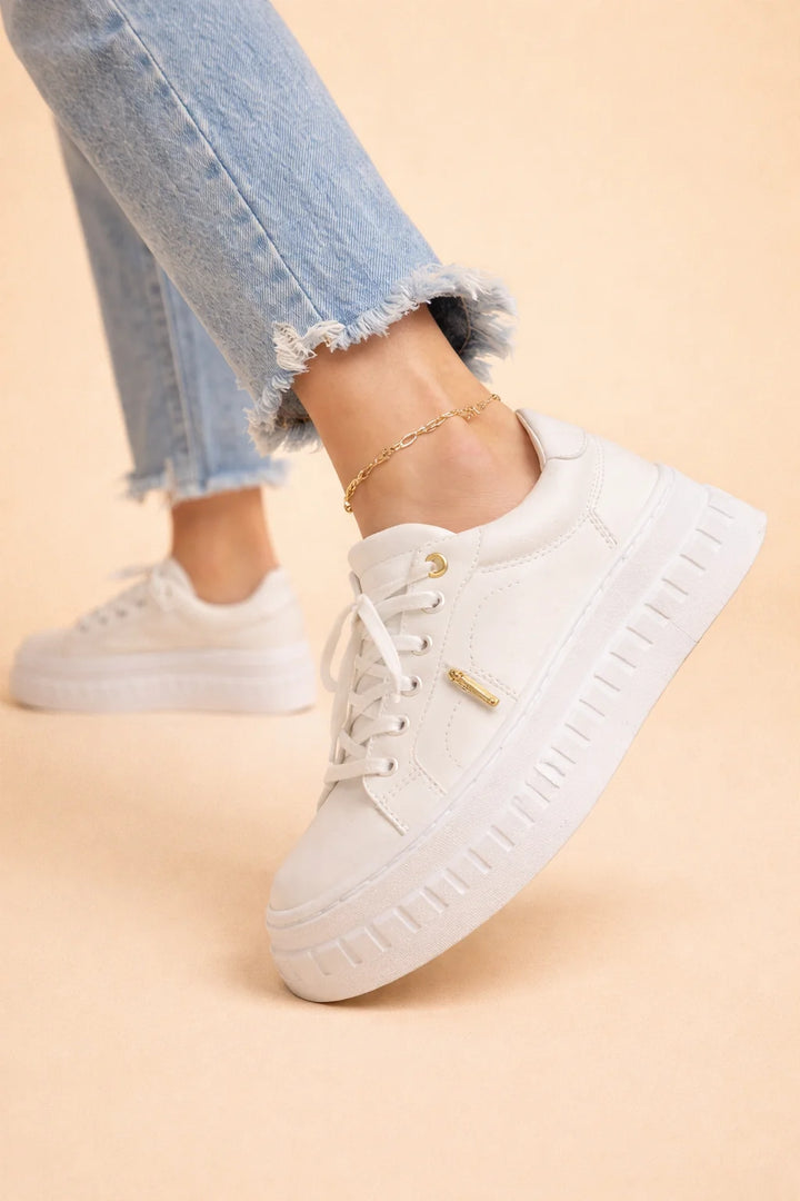 Women's platform comfort sneakers styled with cropped jeans showing height-adding sole