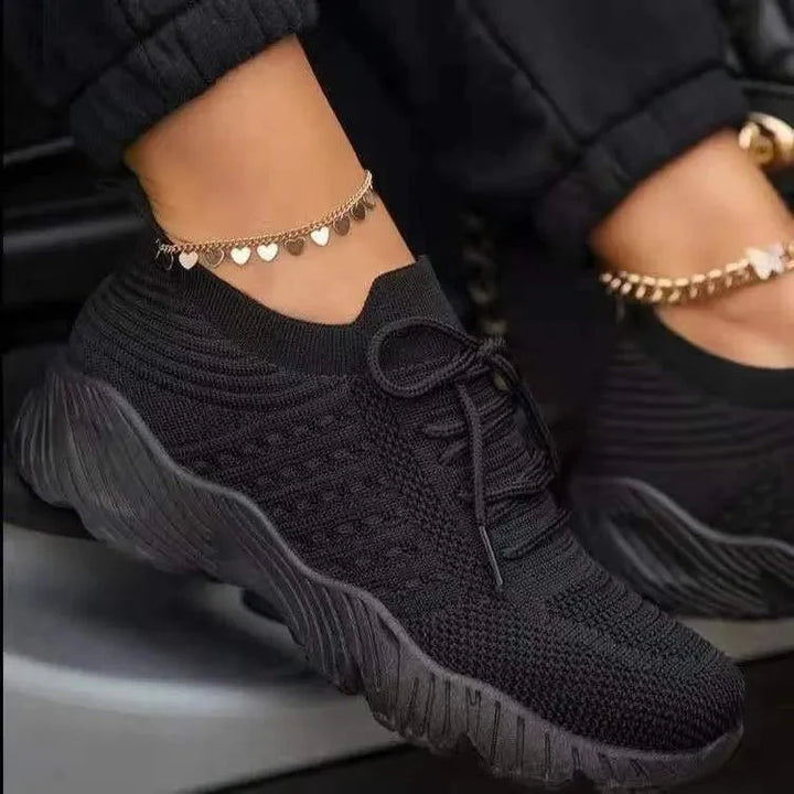 Side profile of women's orthopedic sneakers highlighting slip-resistant rubber outsole and flexible design for natural movement