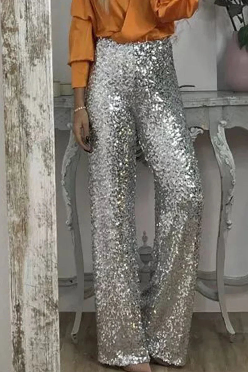 Detail shot of sequin embellishment on women's party pants showing light-catching sparkle and texture