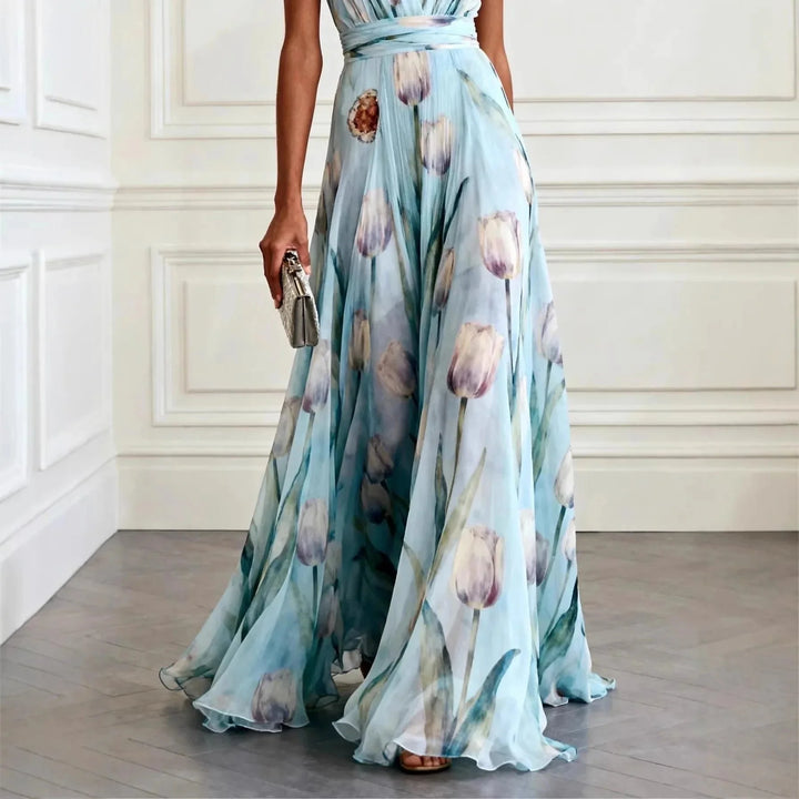 Side view of flowing maxi wrap dress showing pleated fabric and floor-length hem