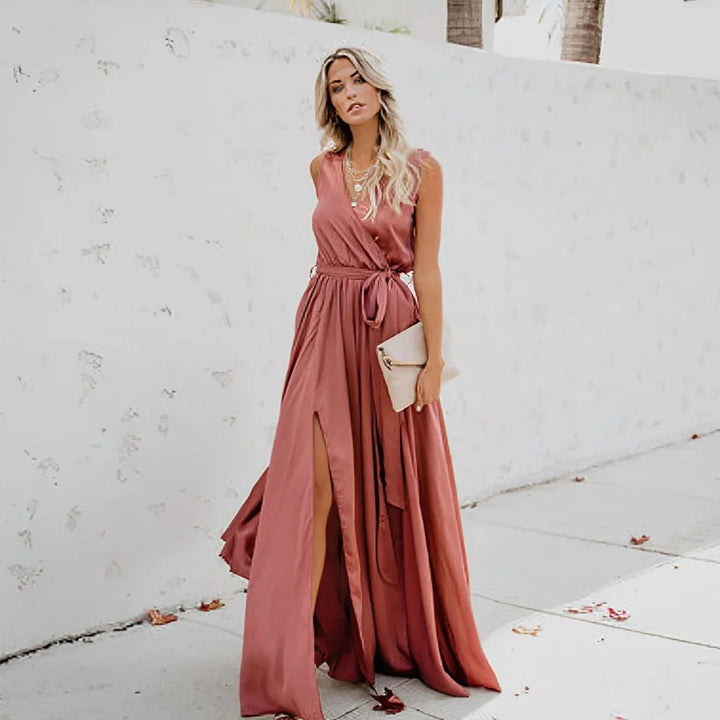 Full-length sleeveless maxi dress with side slit styled with white heels