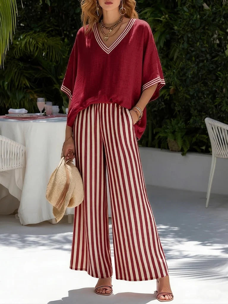 Woman wearing Women's Striped V-Neck Top Wide Leg Pants Set in burgundy with vertical striped trousers and contrast trim