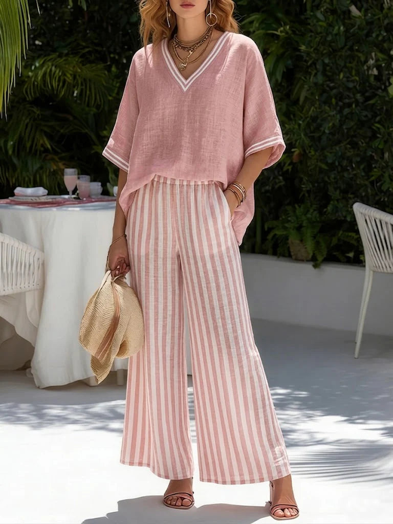 Close-up view of V-neck top with striped trim detail and relaxed short sleeves on coordinated two-piece set