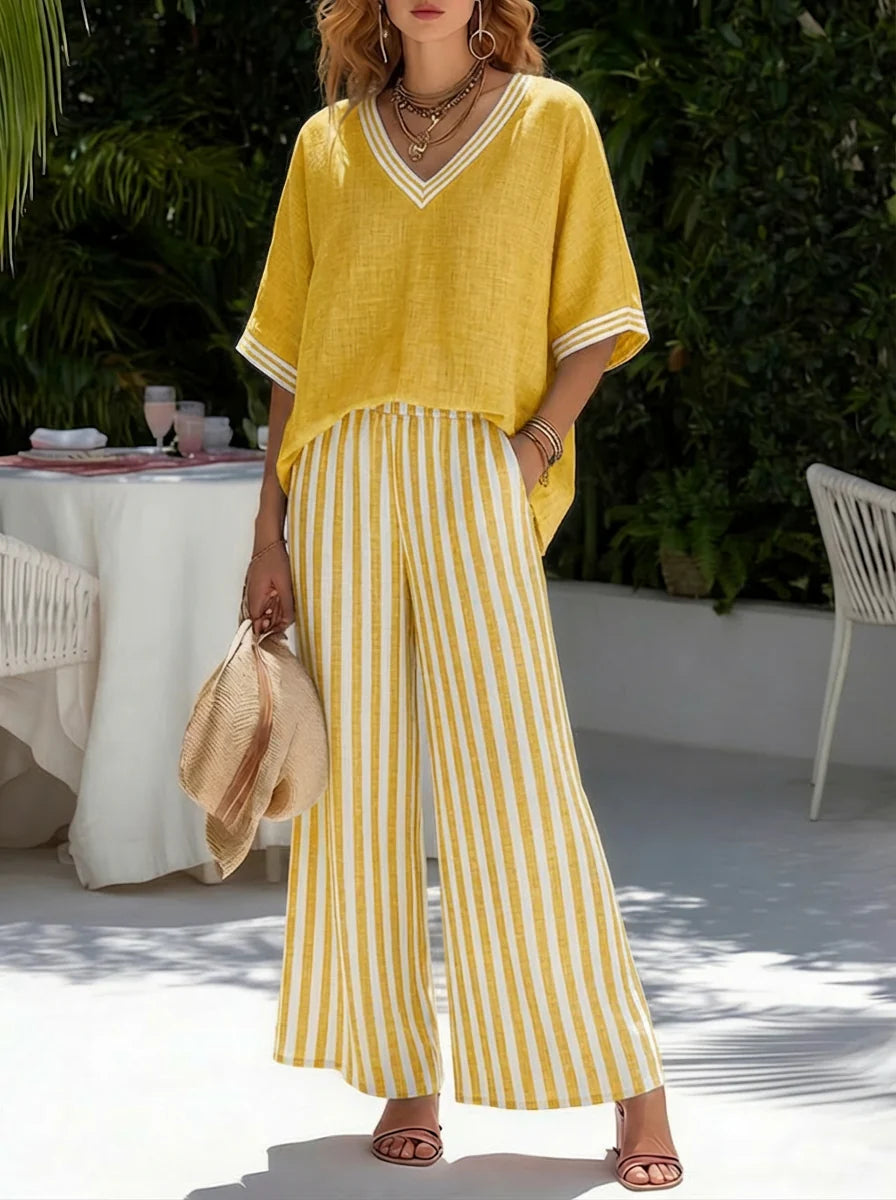 Full-length view of burgundy striped two-piece set styled with sandals for casual summer occasions