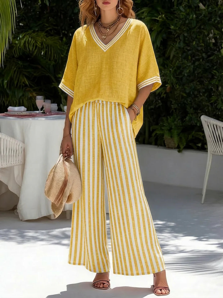 Full-length view of burgundy striped two-piece set styled with sandals for casual summer occasions