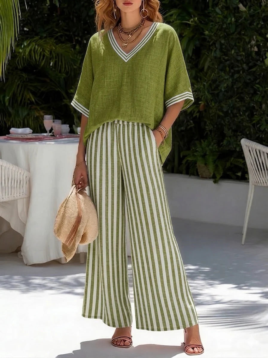 Detail of coordinating striped pattern on wide-leg trousers paired with solid V-neck top