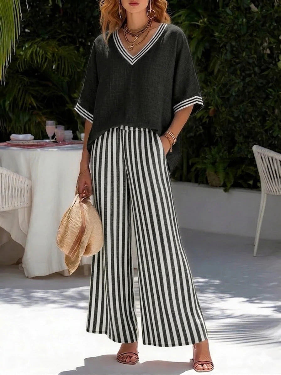 Woman styling burgundy striped set with accessories showing versatile casual outfit combination
